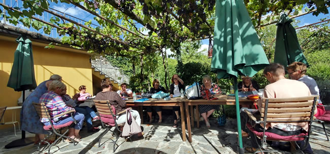 Knitting in the vine courtyard at the watermill